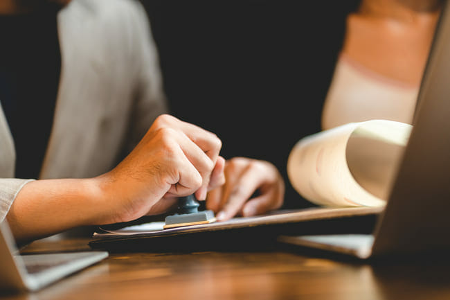 a person using a laptop computer sitting on top of a table